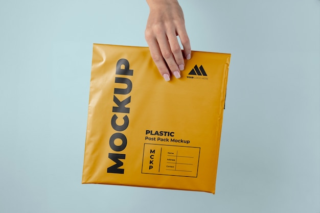 PSD plastic post pack mockup held in hands