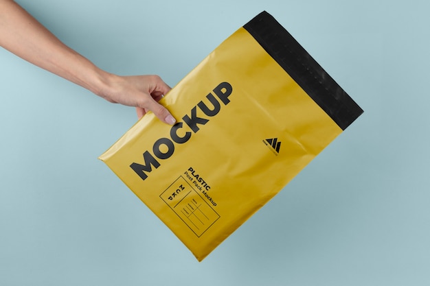 PSD plastic post pack mockup held in hands