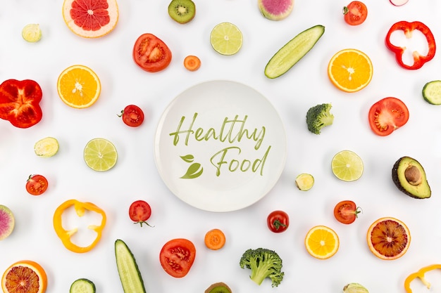 Plate surrounded by veggies and fruit top view