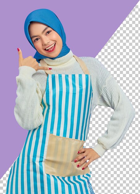 Portrait of cheerful young housewife woman in hijab and striped apron doing phone gesture like says call me back isolated on purple background people housewife muslim lifestyle concept