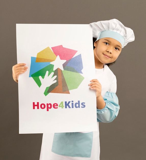 Portrait of cute little girl holding mock-up sign