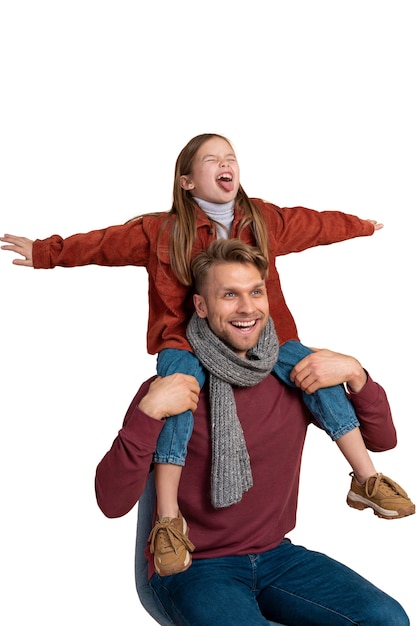 Portrait of father carrying daughter on shoulders with open arms