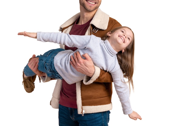 PSD portrait of father playing airplane with daughter for traveling