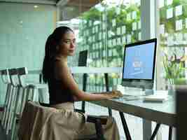 PSD portrait of female entrepreneur using computer mockup