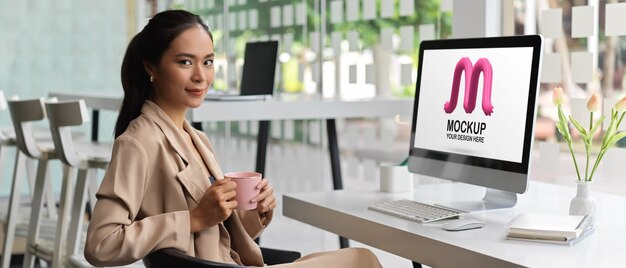 Portrait of female entrepreneur using computer mockup