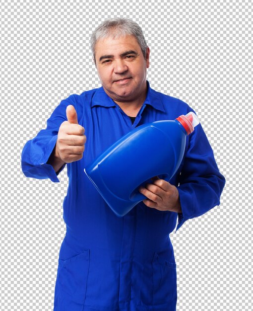 Portrait of a mechanic holding an oil bottle