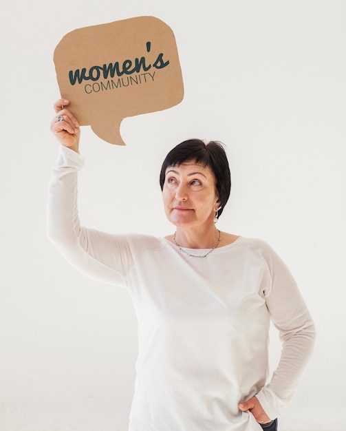 Portrait of senior woman holding mock-up sign