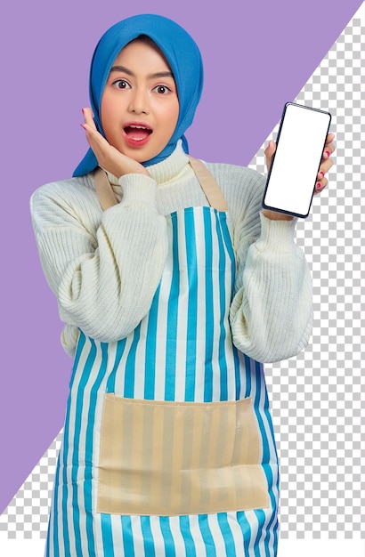 Portrait of surprised young asian muslim woman wearing hijab and apron showing blank screen mobile phone isolated on purple background people housewife muslim lifestyle concept