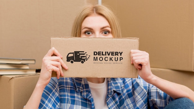 Portrait of woman holding delivery sign with mock-up