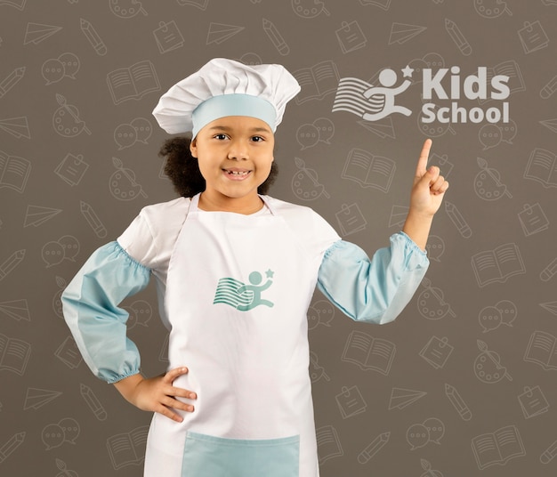 Portrait of young girl posing as chef