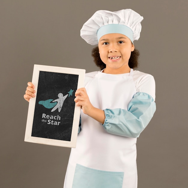 PSD portrait of young girl posing as chef