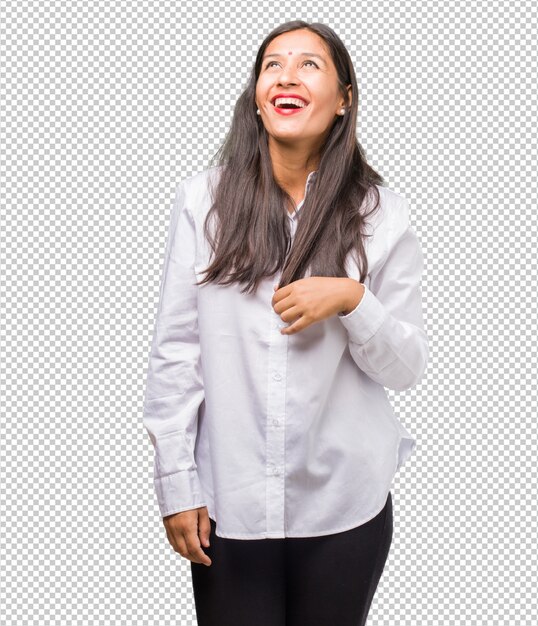 Portrait of a young indian woman looking up, thinking of something fun and having an idea