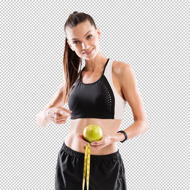 Portret van een glimlachende jonge fitnessvrouw met een groene appel