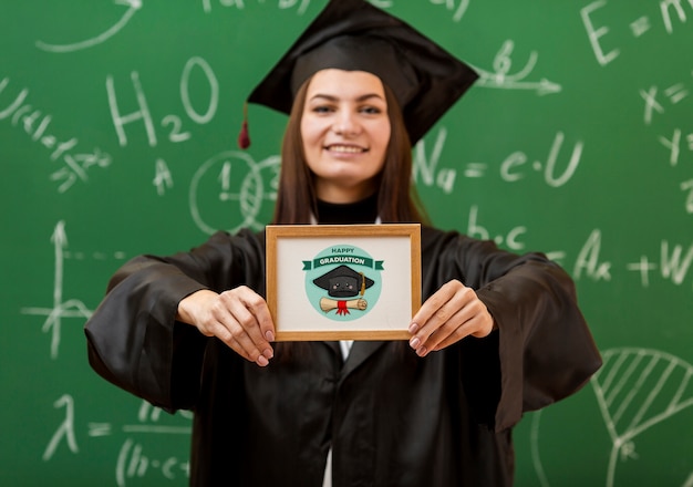 Positive young girl holding diploma