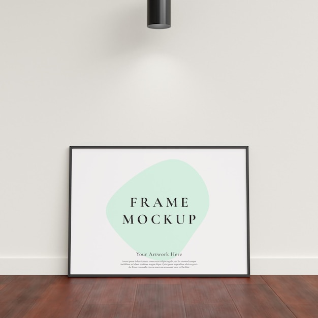 Poster photo frame mockup leanings against the white wall on wooden floor