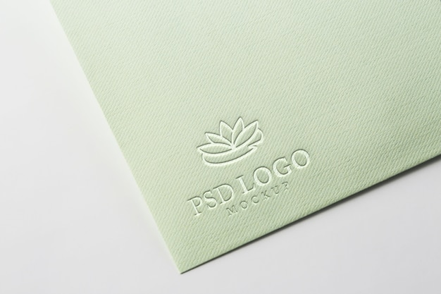 PSD pressed logo mock-up on paper corner close-up
