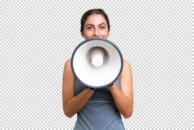 pretty Sport Uruguayan woman over isolated background shouting through a megaphone