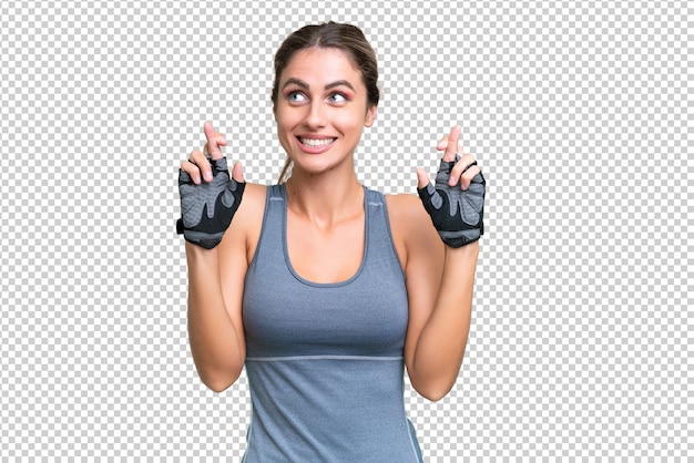 PSD pretty sport uruguayan woman over isolated background with fingers crossing