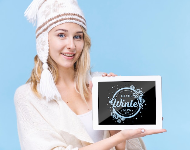 Pretty young girl holding tablet with mock-up