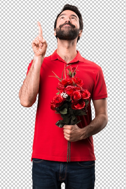 PSD przystojny mężczyzna trzyma kwiaty wskazuje up