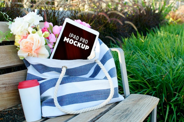 PSD iPad pro mockup coffee mug and flower near on the bag