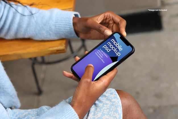 PSD iPhone Mockup featuring black woman holding mobile phone