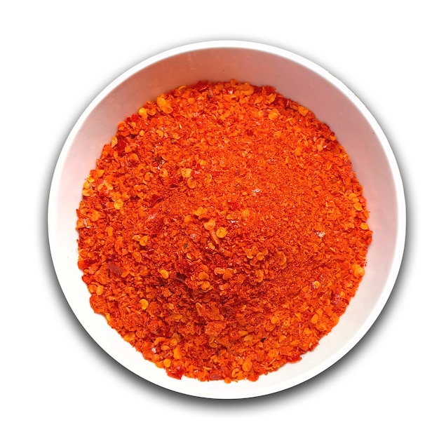 Psd Red chilli powder in white bowl on isolated background