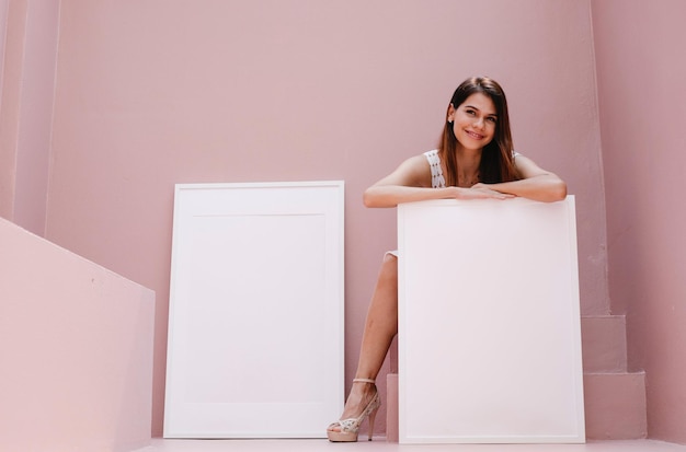 PSD psd white frames held by a woman with a pink background