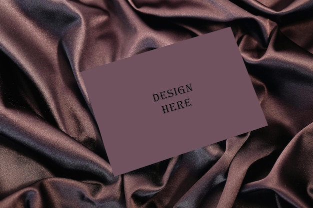 purple card on smooth purple fabric psd mockup