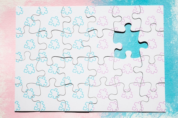 Puzzle pieces on pink and blue background