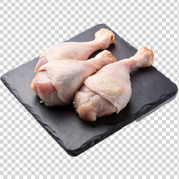 PSD raw chicken legs on black slate plate isolated on transparent background