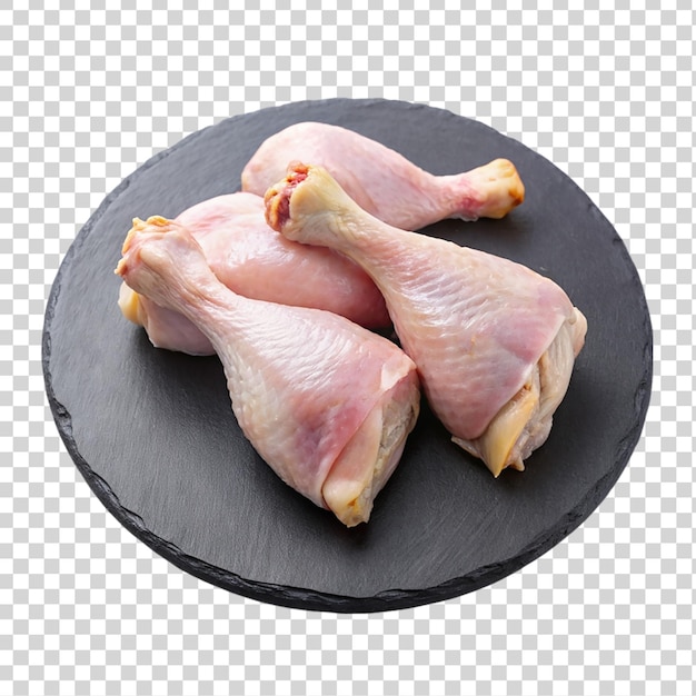 PSD raw chicken legs on black slate plate isolated on transparent background