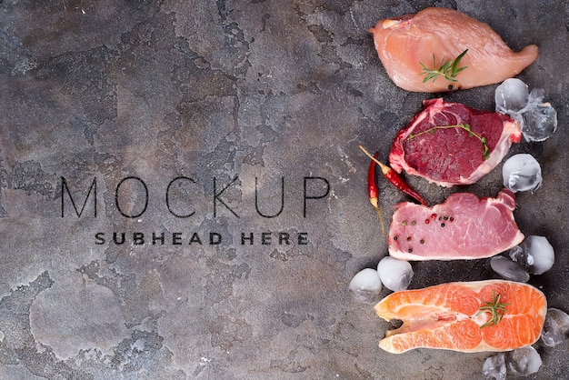 PSD raw chicken, meat and fish with ice and spices mockup on stone.