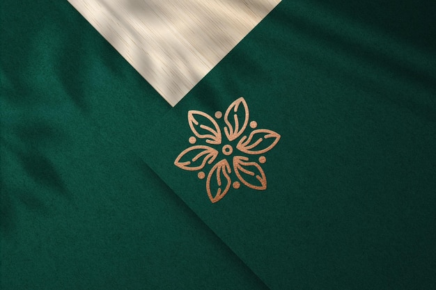 Realistic embossed logo mockup with bronze foil on green paper