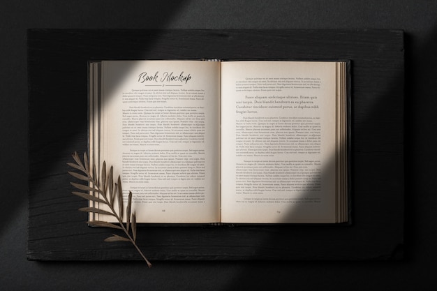Realistic open book mockup template with dry leaves