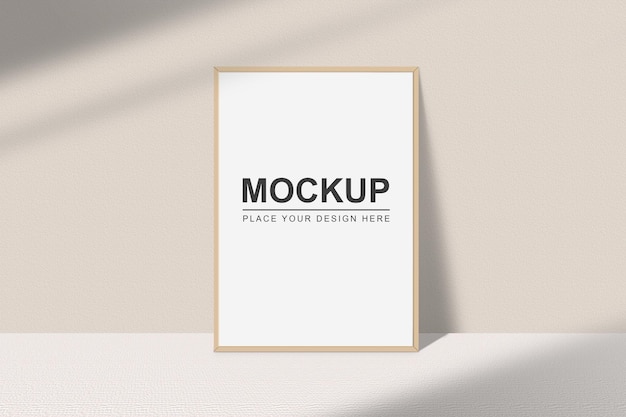 Realistic portrait photo frame mockup Wooden frame mockup on a white wall with shadow