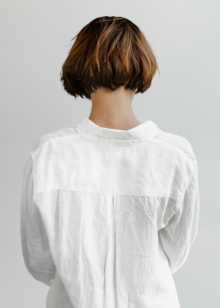 Rear view of a short dyed hair in a white shirt