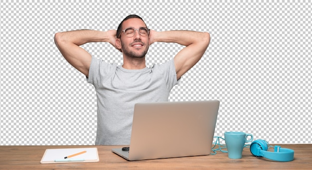 PSD relaxed young man sitting at his desk