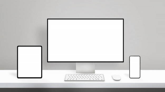 現代のさまざまなディスプレイデバイスモックアップのレスポンシブデザイン。きれいなオフィスの机の上のコンピューターディスプレイ、タブレット、スマートフォン