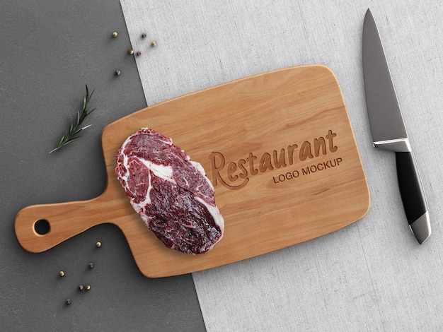 Restaurant logo mockup cooking concept with wooden cutting board steak kitchen decoration isolated