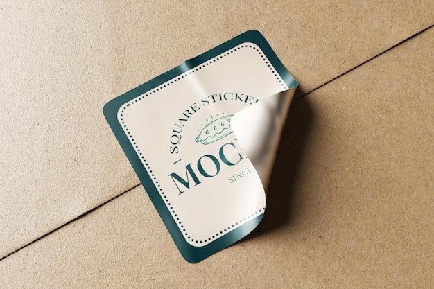 PSD rounded square sticker glued on brown kraft paper realistic mockup