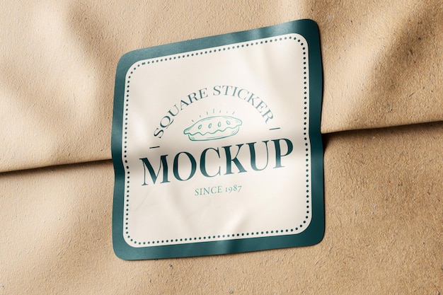 rounded square sticker glued on brown kraft paper realistic mockup