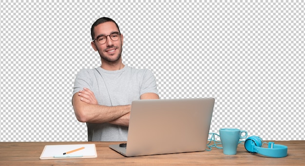 satisfied young man sitting at his desk