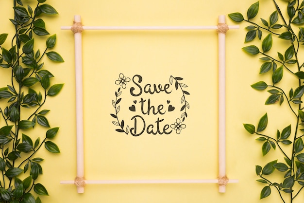 Save the date mock-up frame with small branches with leaves