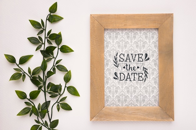 Save the date mock-up wooden frame and plant