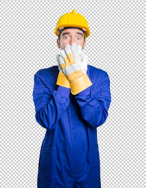 Scared workman covering his mouth with his hand on white background