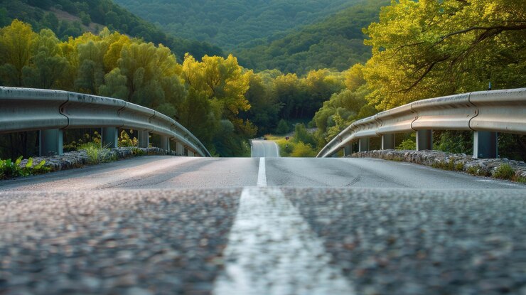 PSD scenic mountain road descending into a lush green valley