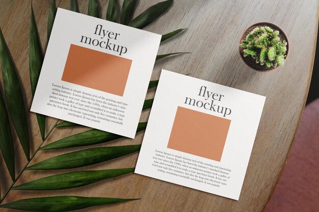 PSD schone minimale vierkante flyer mockup op tafelachtergrond met verlof en plant