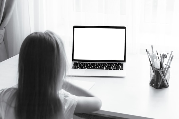 school at home through online homeschooling the child is sitting at the computer