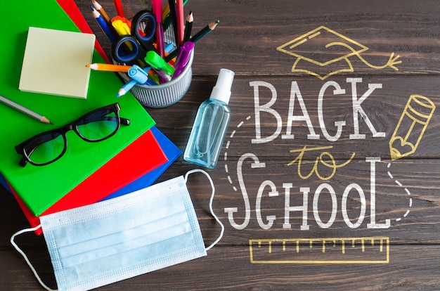 School supplies with medical mask and sanitizer mockup